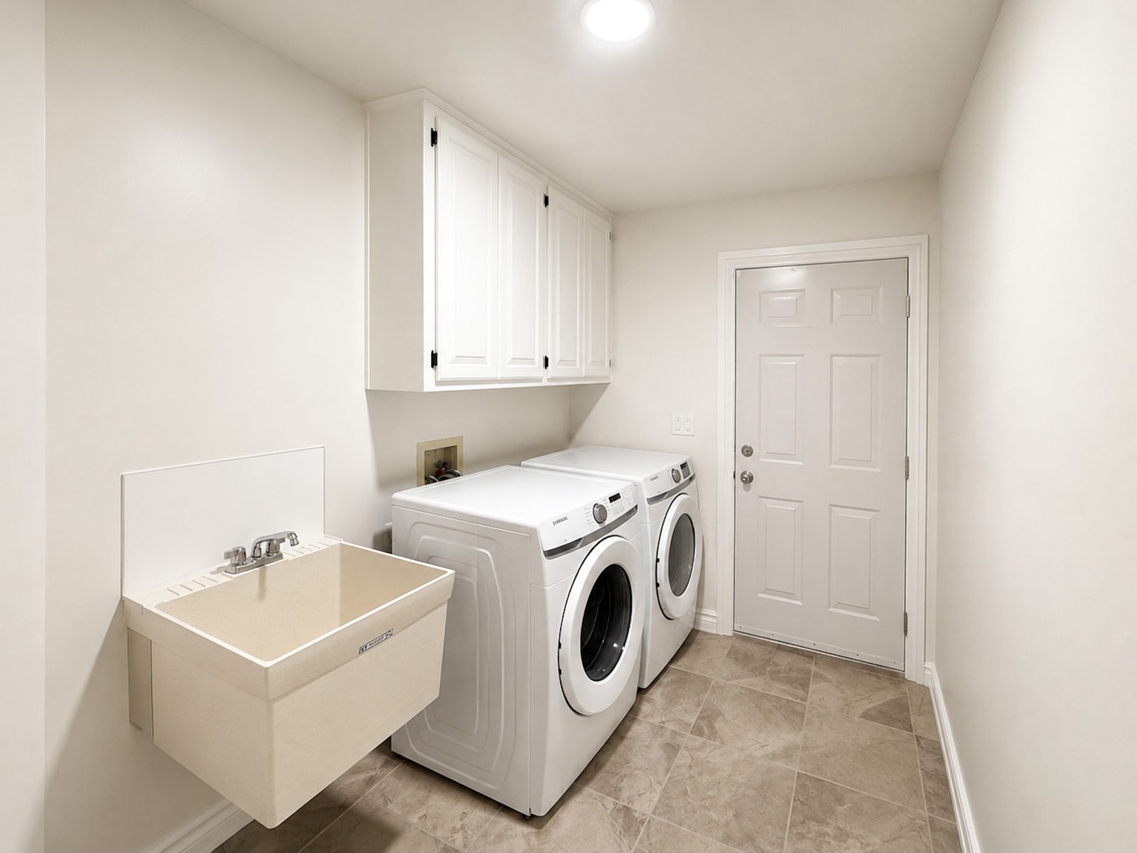 Laundry room with washer, dryer and utility sink at Casa Rita, Bentonville AR