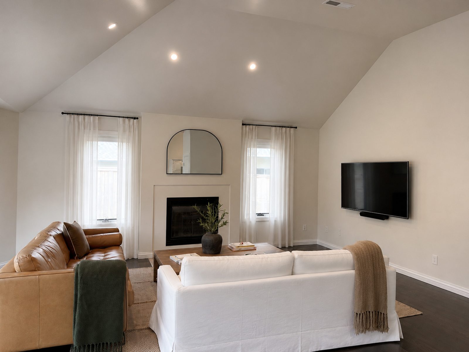 Furnished living room with vaulted ceiling, fireplace and Sonos sound at Casa Rita, Bentonville AR